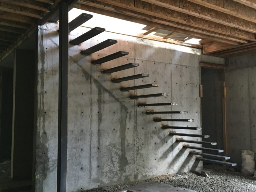 Aligning Floating Stair Supports During Installation at Chartwell, West Vancouver