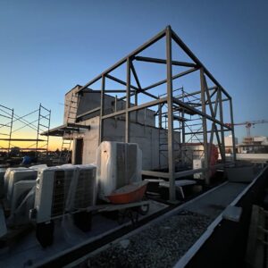 Installing Roof Support Steel Trusses at 8486 Oak Street, Vancouver Modern steel frame house construction in Canada showing structural steel framing system