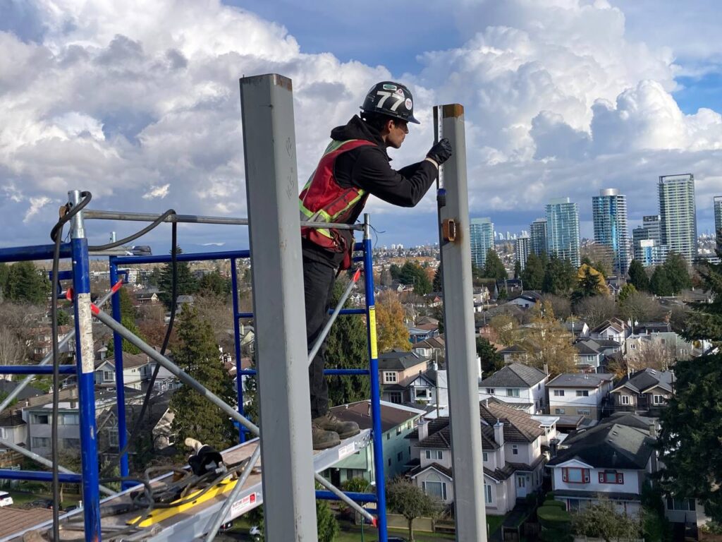 Site Workers Assembling Steel Structure Framework at 8486 Oak Street, Vancouver