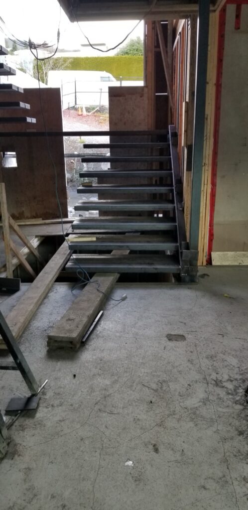 Custom steel stair frame before finishing at 690 Knockmaroon Rd., West Vancouver