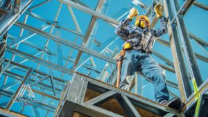 Contractor staking out dimensions for a proposed steel building foundation