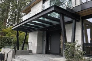 Structural steel entrance canopy with glass roof at a modern West Vancouver residence